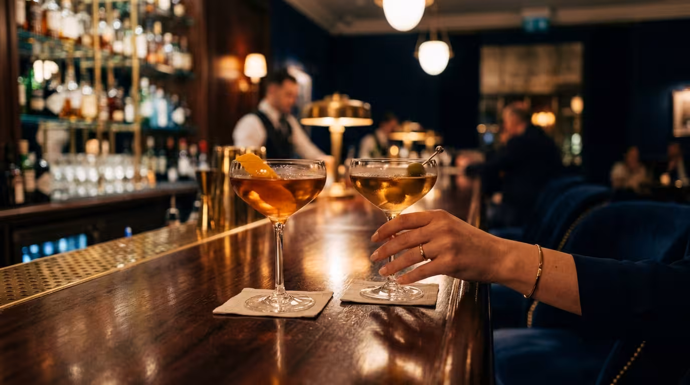 Two cocktail glasses at a London hotel bar — the setting for a first sugar date in the capital